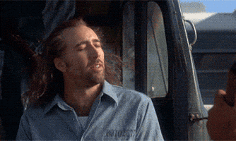 Nicolas cage with his hair in the wind